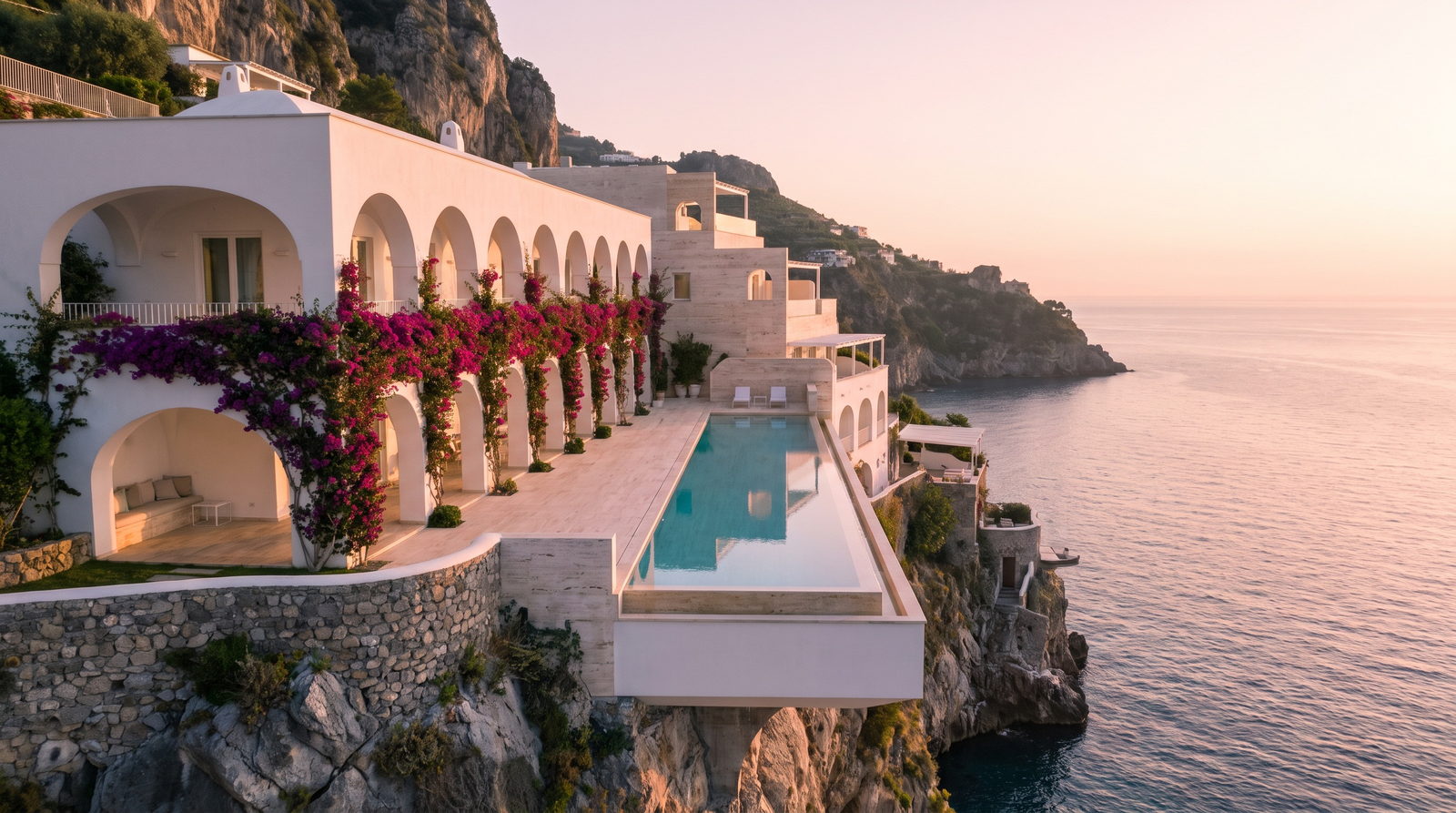 Contemporary clifftop villa on the Amalfi coast at sunrise, with a lap pool cantilevered over the sea
